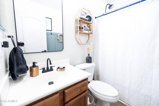 bathroom featuring toilet, curtained shower, and vanity