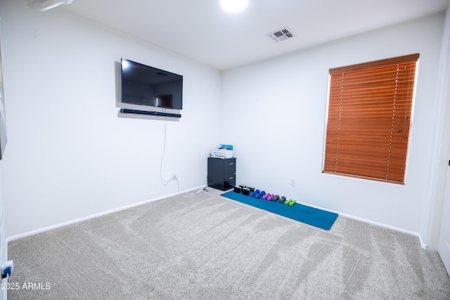 exercise room with carpet flooring, visible vents, and baseboards