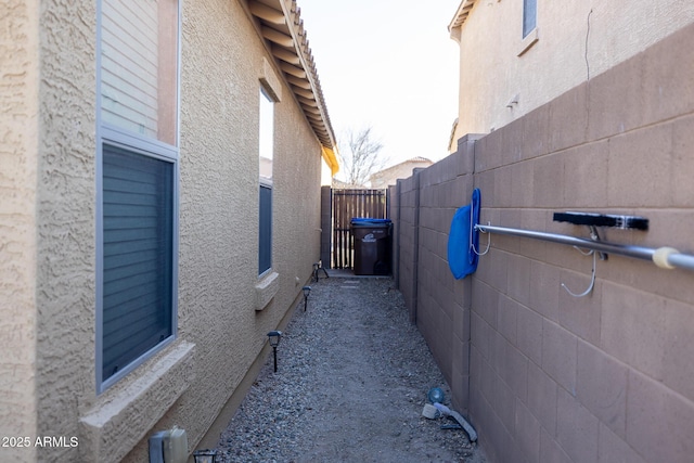 view of property exterior featuring fence and stucco siding