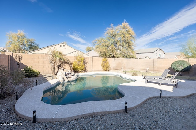 view of swimming pool featuring a patio, a fenced backyard, and a fenced in pool