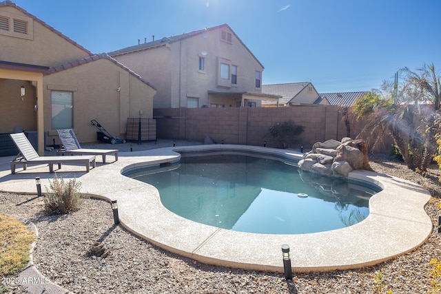 view of swimming pool with a patio area, a fenced backyard, and a fenced in pool