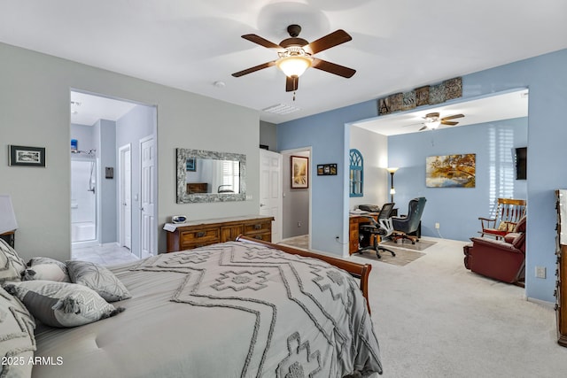 bedroom with ceiling fan, light carpet, and ensuite bathroom