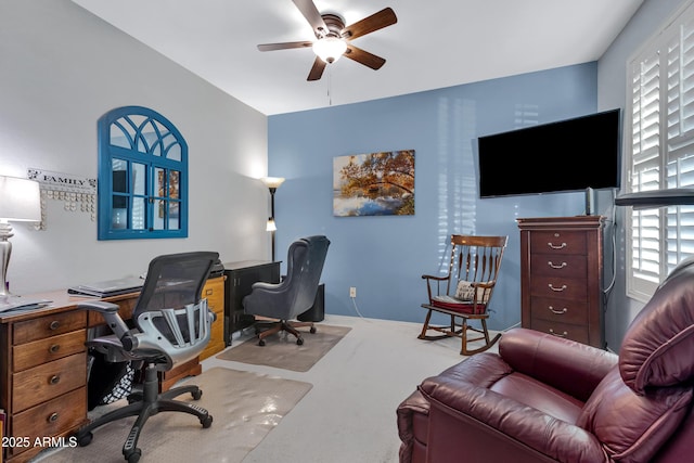 carpeted home office with ceiling fan