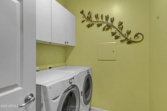 washroom featuring washing machine and dryer and cabinets