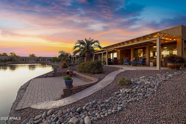 exterior space featuring a water view and a patio