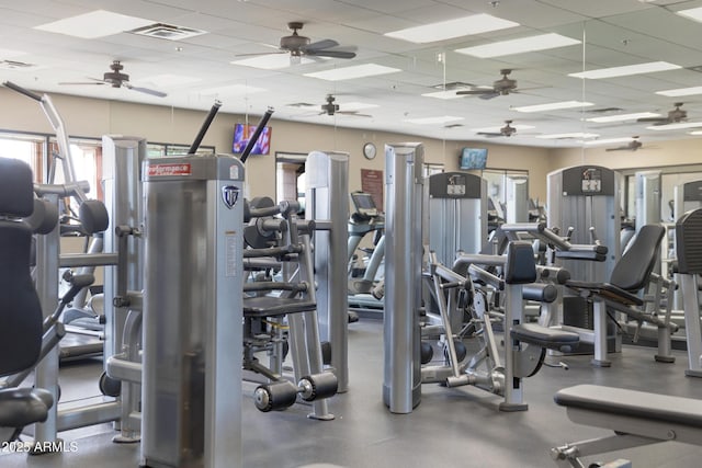workout area featuring visible vents, a paneled ceiling, and ceiling fan