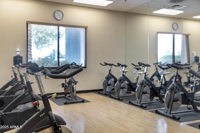 gym with a drop ceiling and wood finished floors