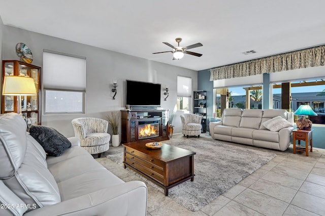 living room featuring ceiling fan and light tile patterned floors