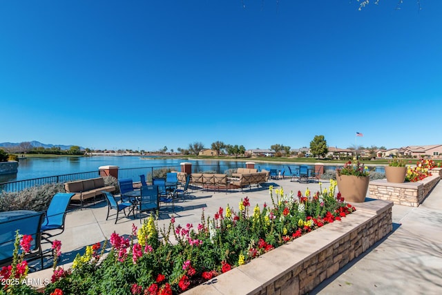 view of patio with an outdoor hangout area and a water view