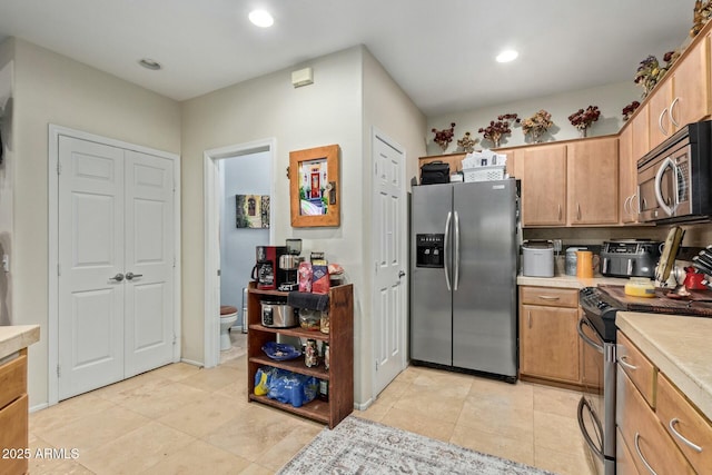 kitchen featuring appliances with stainless steel finishes, recessed lighting, light countertops, and light tile patterned floors