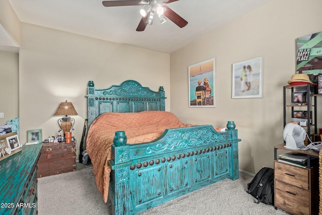 carpeted bedroom with ceiling fan and baseboards