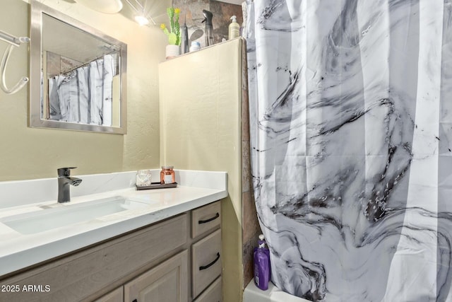 bathroom with curtained shower and vanity