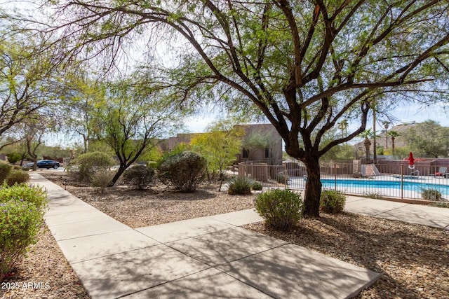 surrounding community with a swimming pool and fence