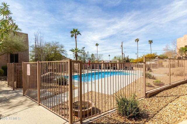 view of swimming pool featuring fence and a fenced in pool