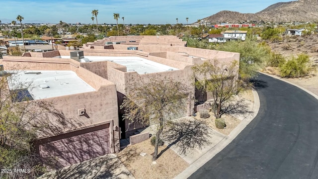 birds eye view of property with a mountain view