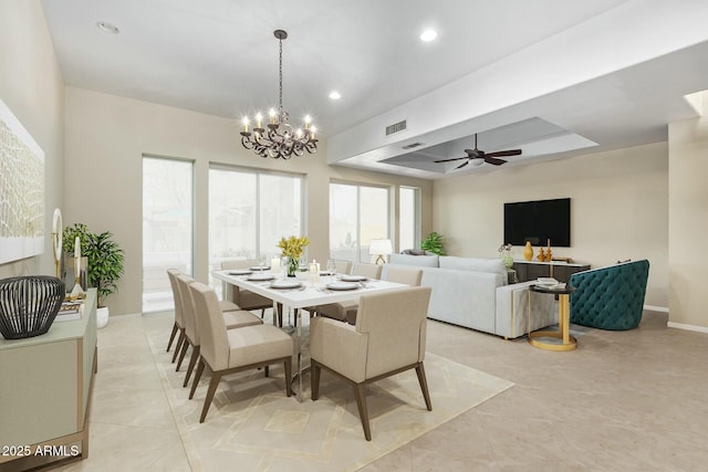 dining room featuring recessed lighting, ceiling fan with notable chandelier, visible vents, baseboards, and a raised ceiling