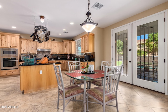 kitchen featuring stainless steel appliances, a wealth of natural light, hanging light fixtures, and french doors