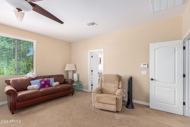 carpeted living room with ceiling fan