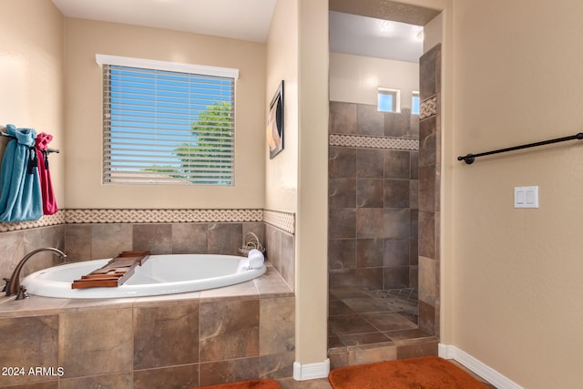 bathroom featuring separate shower and tub