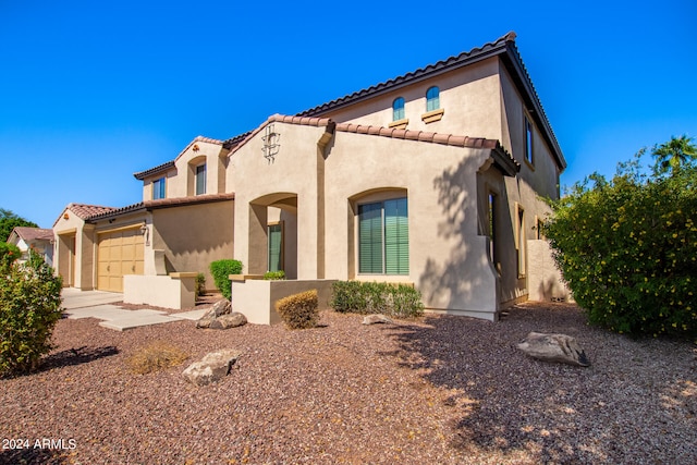 mediterranean / spanish-style house featuring a garage