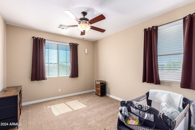 interior space with ceiling fan and light carpet