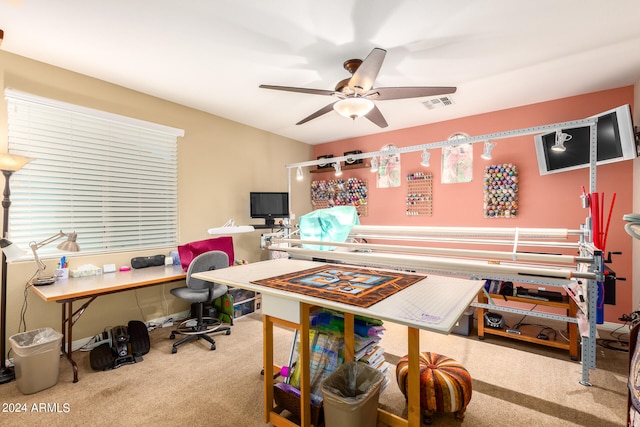 carpeted home office featuring ceiling fan