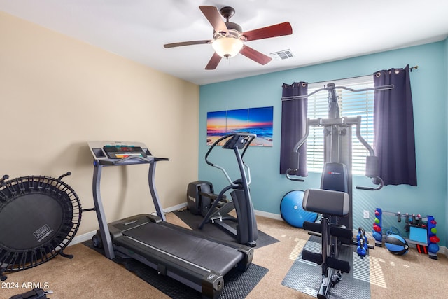 exercise room featuring ceiling fan and light colored carpet