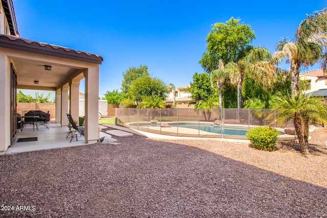 view of yard featuring a patio and a fenced in pool