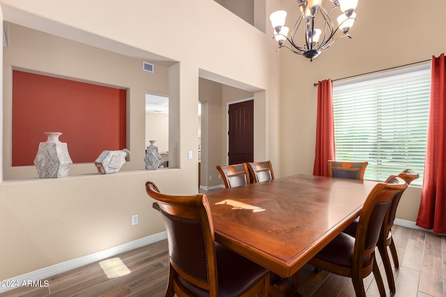 dining room with a notable chandelier and hardwood / wood-style floors