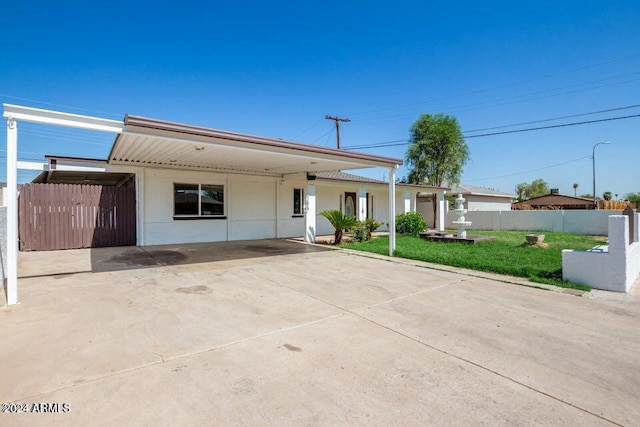 single story home with a front lawn and a carport