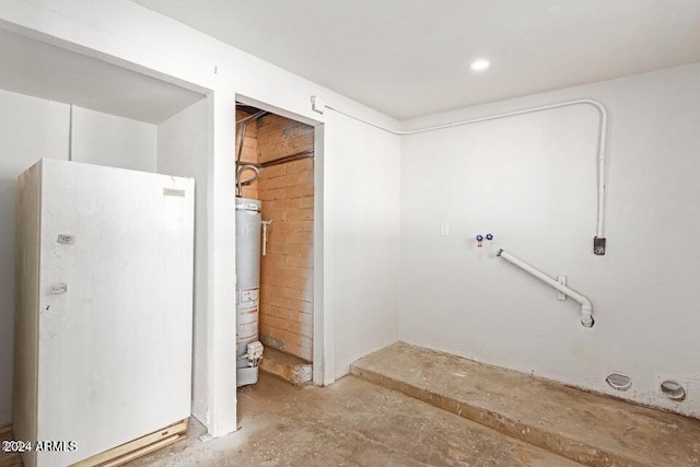 interior space with water heater and concrete flooring