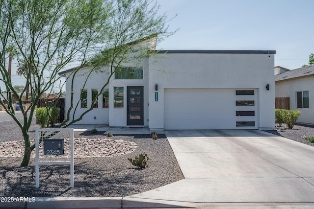 2345 N 28th Pl, Phoenix, AZ 85008 - contemporary house with stucco siding, an attached garage, and driveway