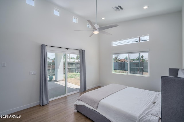 2345 N 28th Pl, Phoenix, AZ 85008 - bedroom with access to outside, baseboards, wood finished floors, recessed lighting, and a towering ceiling