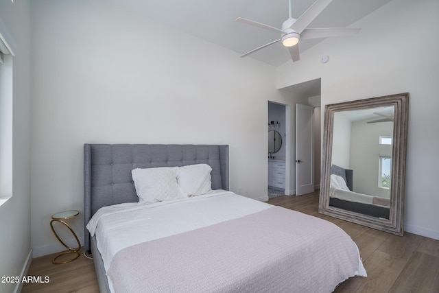 2345 N 28th Pl, Phoenix, AZ 85008 - bedroom with wood finished floors, baseboards, ensuite bath, lofted ceiling, and ceiling fan