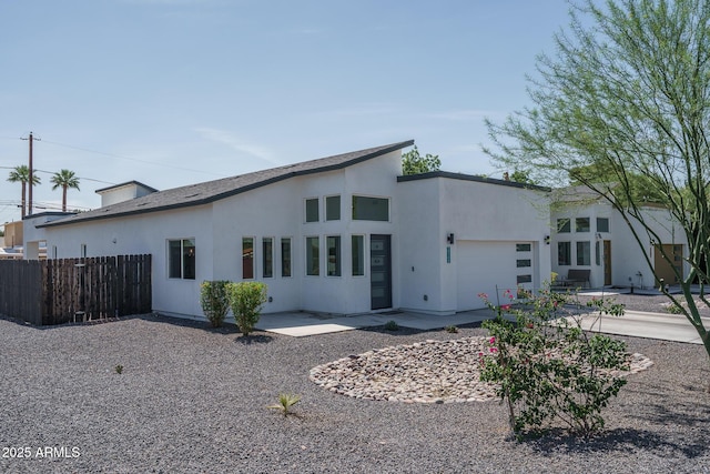 2345 N 28th Pl, Phoenix, AZ 85008 - view of side of home featuring a garage, driveway, and stucco siding