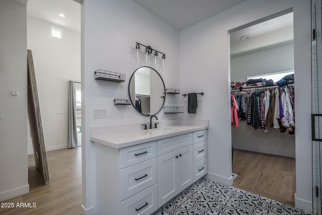 2345 N 28th Pl, Phoenix, AZ 85008 - bathroom featuring vanity, wood finished floors, a spacious closet, baseboards, and recessed lighting