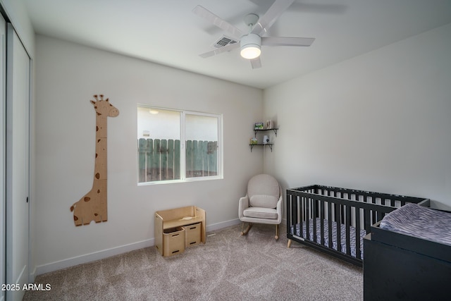 2345 N 28th Pl, Phoenix, AZ 85008 - bedroom with a nursery area, carpet floors, a ceiling fan, and baseboards
