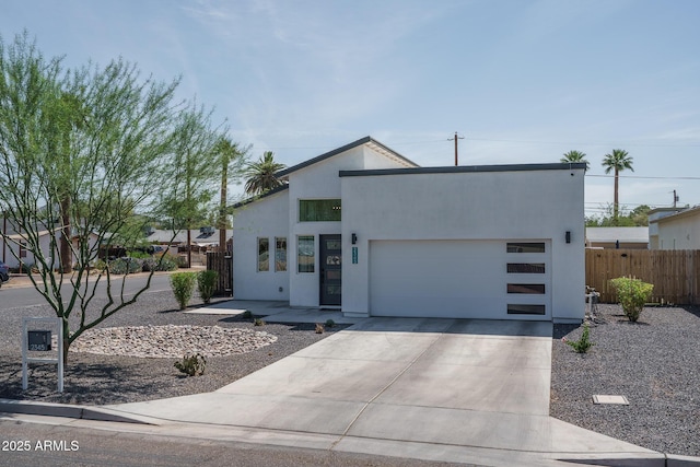 2345 N 28th Pl, Phoenix, AZ 85008 - view of front facade featuring driveway, an attached garage, and stucco siding