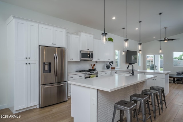2345 N 28th Pl, Phoenix, AZ 85008 - kitchen featuring appliances with stainless steel finishes, light wood-style floors, healthy amount of natural light, white cabinets, and recessed lighting