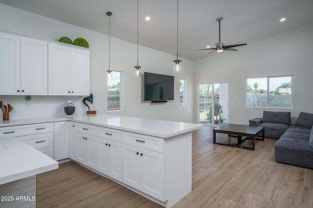 2345 N 28th Pl, Phoenix, AZ 85008 - kitchen featuring open floor plan, a peninsula, a ceiling fan, light countertops, and light wood-type flooring