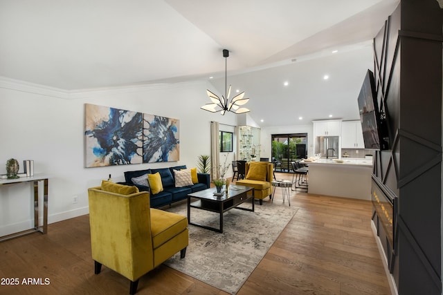 8419 E Rancho Vista Dr, Scottsdale, AZ 85251 - living area with lofted ceiling, a notable chandelier, wood finished floors, and recessed lighting