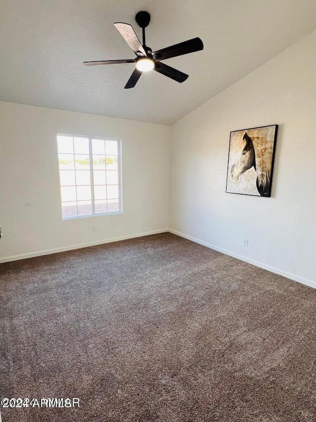 empty room featuring ceiling fan, carpet, and lofted ceiling