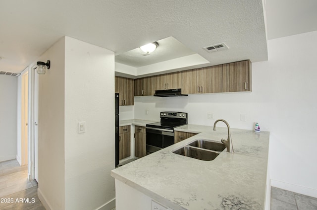 kitchen featuring sink, stainless steel range with electric stovetop, a textured ceiling, a raised ceiling, and kitchen peninsula