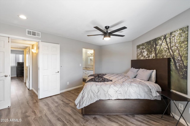 bedroom with hardwood / wood-style flooring, ceiling fan, and ensuite bathroom