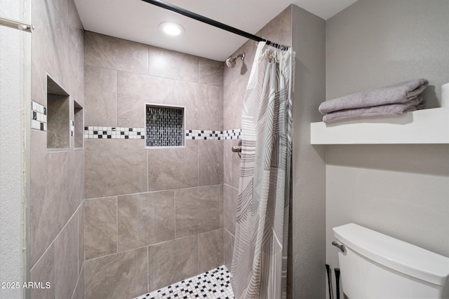 bathroom with walk in shower and toilet