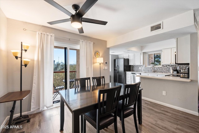 dining room featuring dark hardwood / wood-style floors and ceiling fan