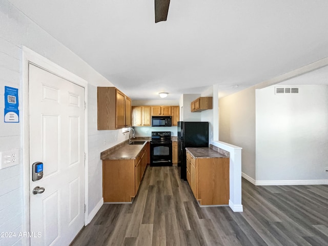 kitchen with sink, black appliances, and dark hardwood / wood-style flooring