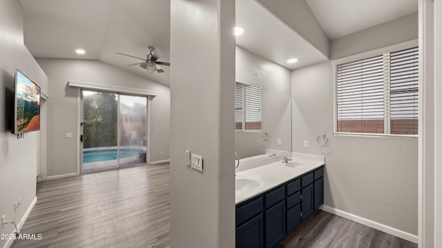 bathroom featuring ceiling fan, hardwood / wood-style floors, vanity, and lofted ceiling