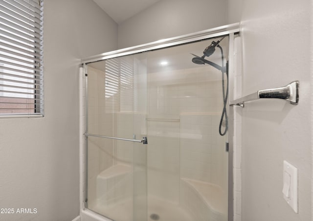 bathroom featuring a shower with door