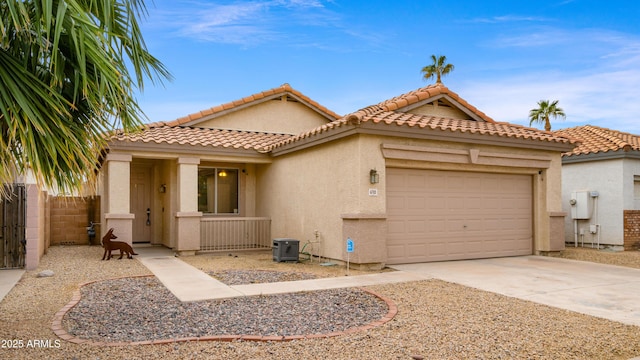 mediterranean / spanish-style house featuring central AC unit and a garage